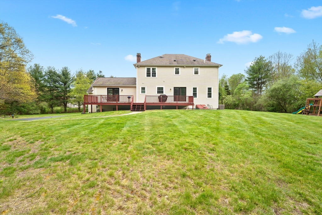 203 Richie Road Attleboro, MA 02703 - Photo 39 of 42 a large tree in front of a house with a yard