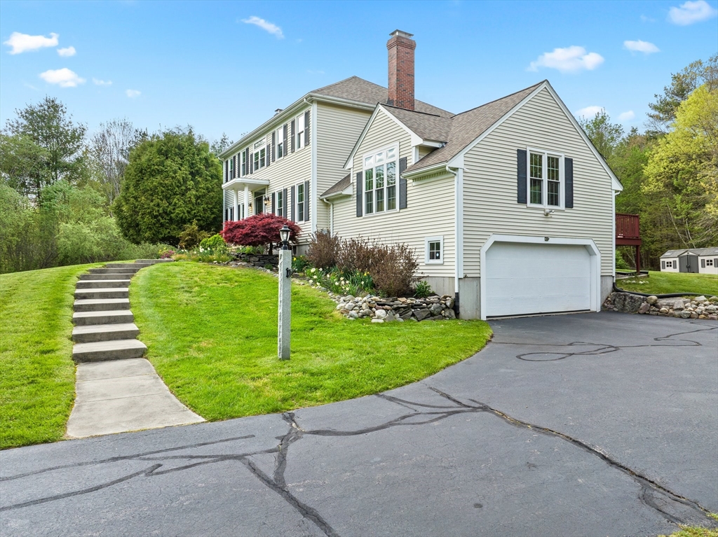 203 Richie Road Attleboro, MA 02703 - Photo 5 of 42 a front view of a house with a yard and garage