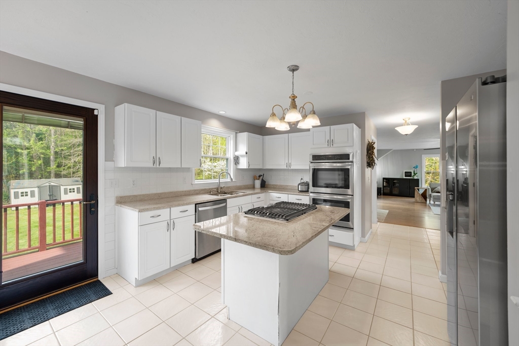 203 Richie Road Attleboro, MA 02703 - Photo 9 of 42 a kitchen with stainless steel appliances granite countertop a stove top oven a sink dishwasher and a refrigerator