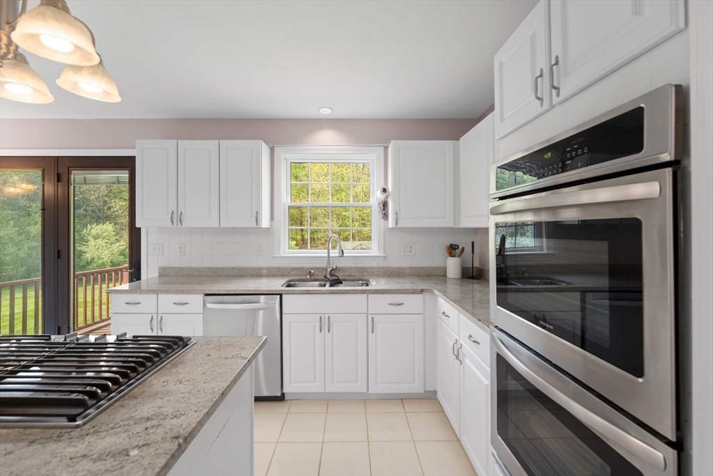 203 Richie Road Attleboro, MA 02703 - Photo 10 of 42 a kitchen with stainless steel appliances a stove sink and microwave