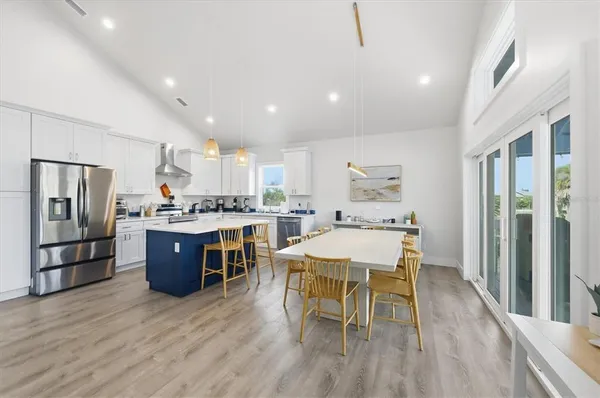 a kitchen with a sink a refrigerator and white appliances