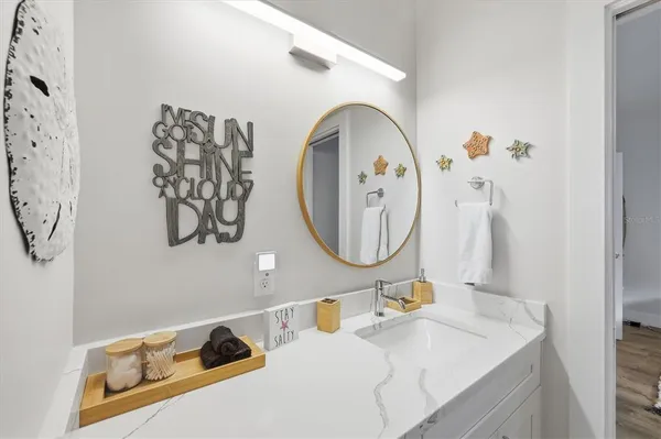 a bathroom with a sink mirror and toilet