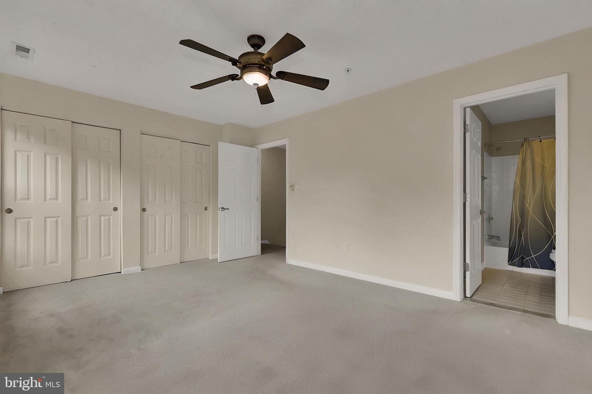 7150 Natures Road Columbia, MD 21046 - Photo 17 of 45 an empty room with a ceiling fan and a window
