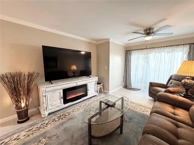 a living room with furniture and a flat screen tv