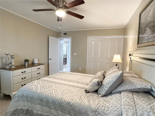 a bedroom with a large bed and a chandelier