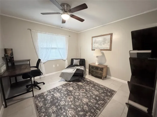 a bedroom with a bed a couch and a chandelier