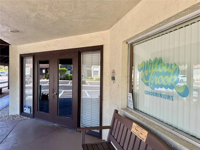 a view of a porch with furniture and floor to ceiling window