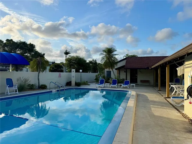 a view of a swimming pool with sitting area