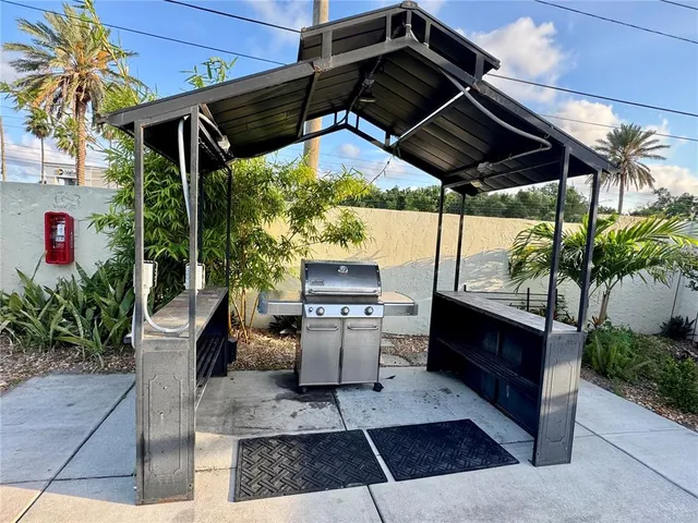 a view of a patio with table and chairs potted plants