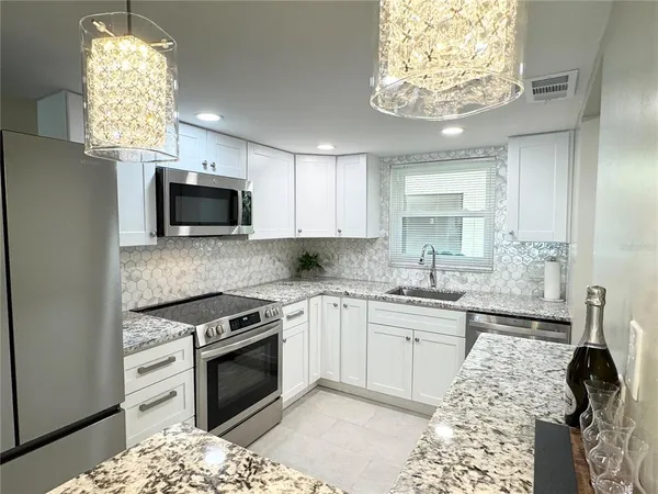 a kitchen with a sink stove and microwave