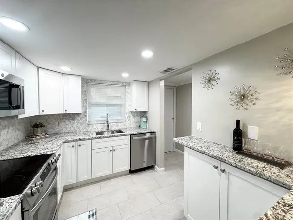 a kitchen with a sink stove and microwave