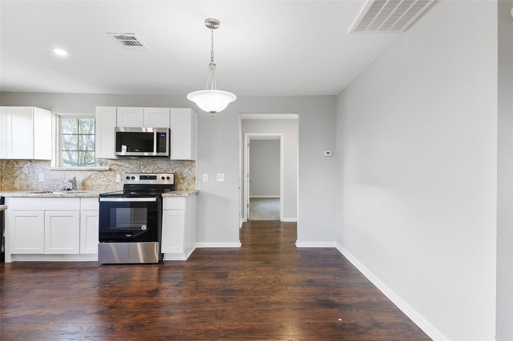 986 Dewalt Street Houston, TX 77088 - Photo 11 of 18 a view of a kitchen with a microwave and stove top oven