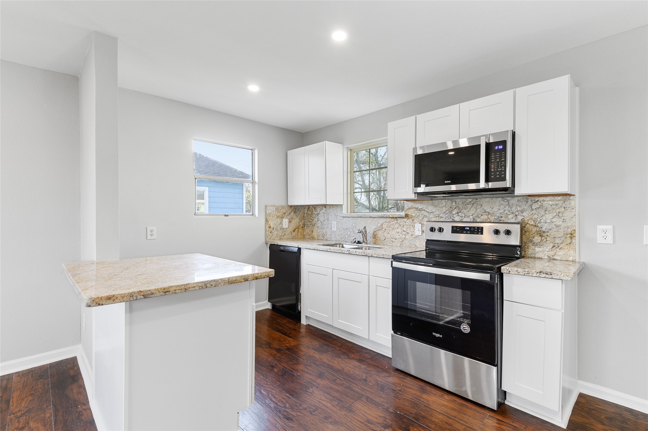 986 Dewalt Street Houston, TX 77088 - Photo 18 of 18 a kitchen with a sink stove and microwave