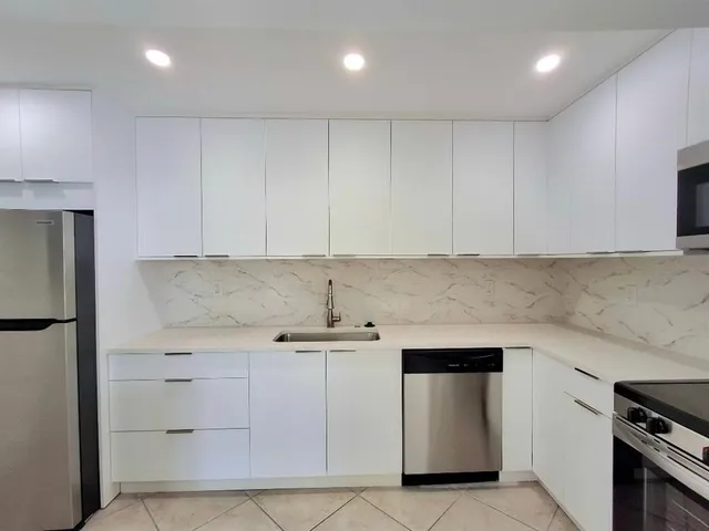 a kitchen with a sink a stove and refrigerator