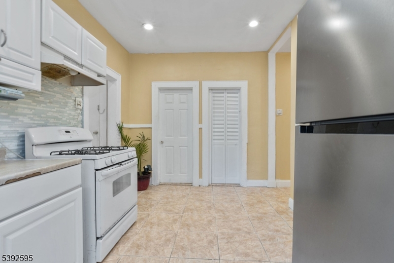 213 Maple Avenue Irvington, NJ 07111 - Photo 5 of 17 a kitchen with a stove a refrigerator and a sink