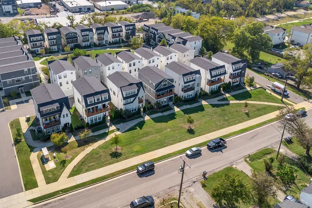 an aerial view of multiple houses with yard