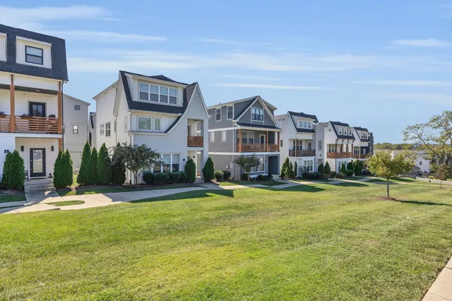 a front view of a house with a yard and swimming pool