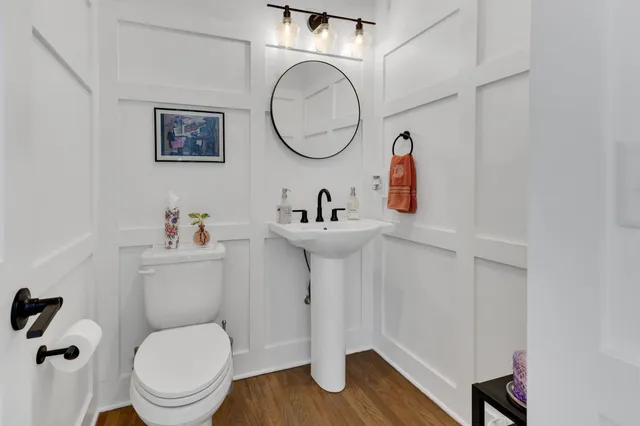 a bathroom with a toilet a sink and a mirror