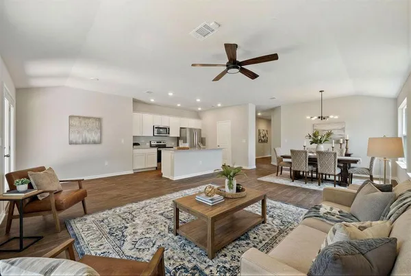 a living room with furniture and kitchen view