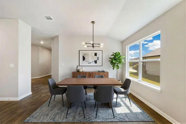 a dining room with furniture and window
