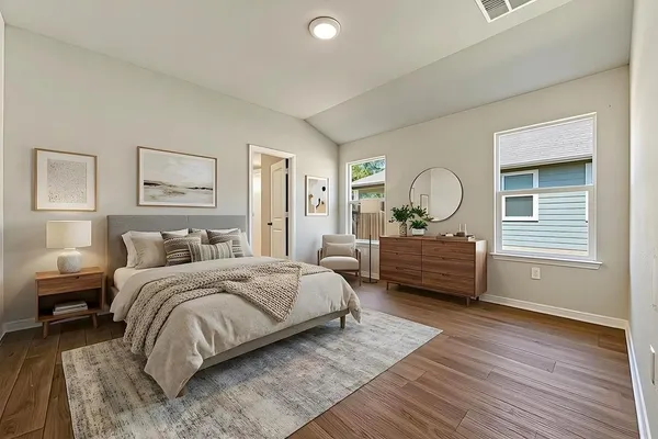 a bedroom with a bed mirror and window