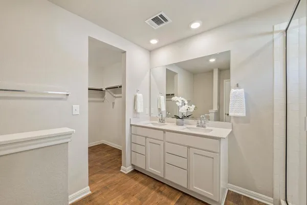 a bathroom with a double vanity sink and mirror