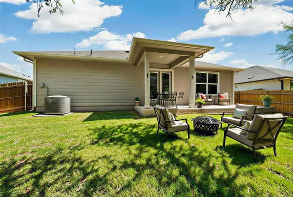 a backyard of a house with outdoor seating