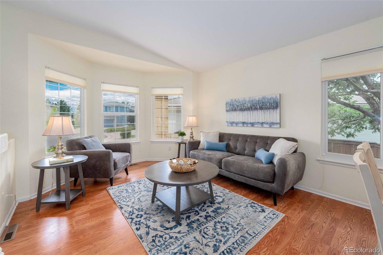 2223 Fox Fire Court Highlands Ranch, CO 80129 - Photo 2 of 34 a living room with furniture a rug a lamp and a table