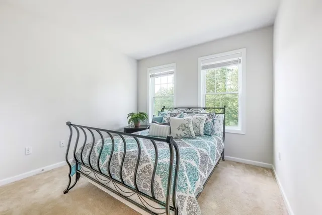 a bed room with a bed and a chair