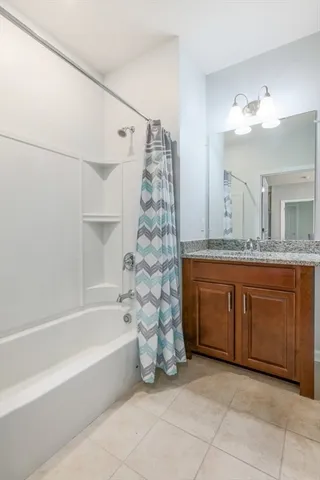 a bathroom with a tub sink and a mirror