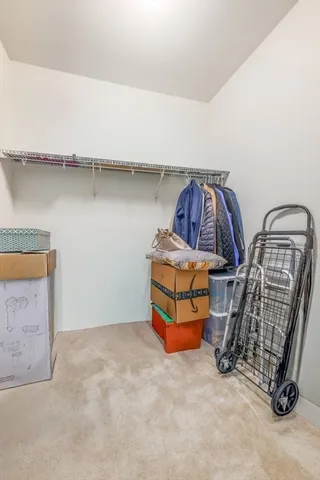 a room with two washing machine with racks on the wall