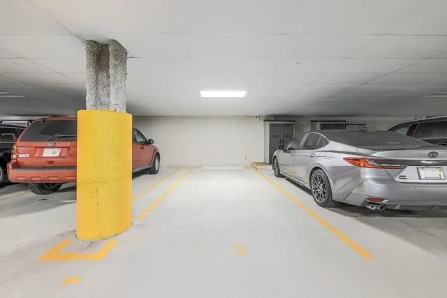 a bedroom with a bed and dresser with mirror