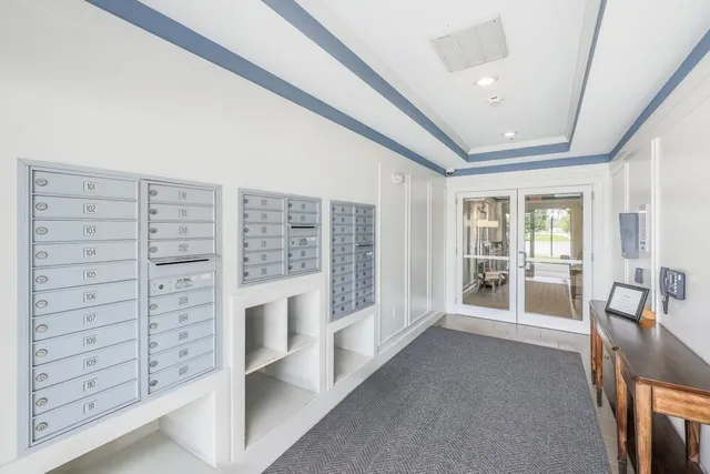 a living room with furniture and large windows