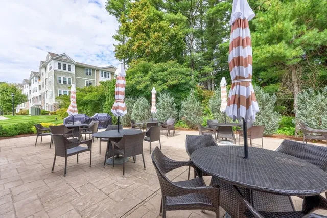 a view of a patio with a table and chairs