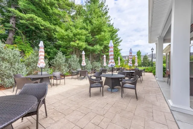 a view of a patio with a dining table and chairs with a table and chairs