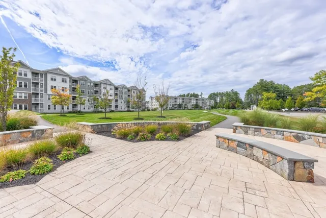 a view of a swimming pool and a yard in front of it