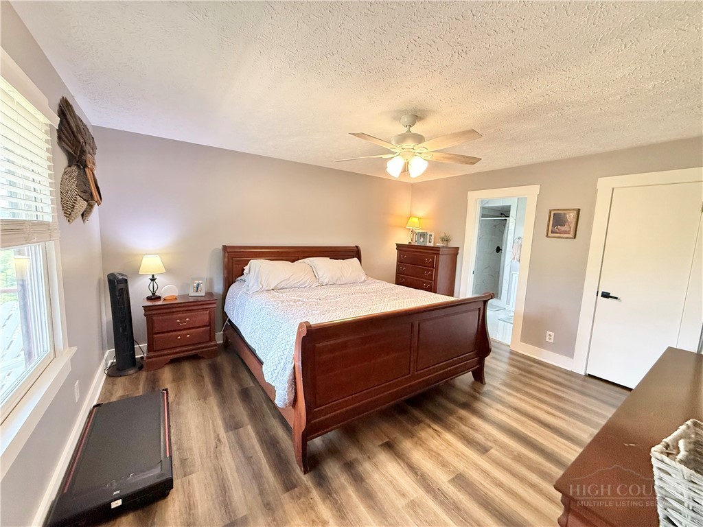 1315 Irwin Grocery Road Laurel Springs, NC 28644 - Photo 11 of 22 a spacious bedroom with a bed and a chandelier