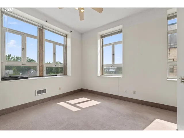a living room with furniture a flat screen tv and a window