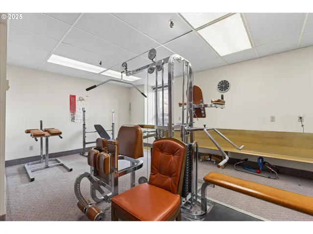 a room with gym equipment and mirror