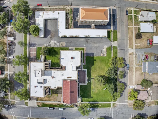 an aerial view of a house with a yard