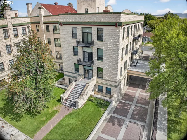 a view of a swimming pool with a big yard and large trees