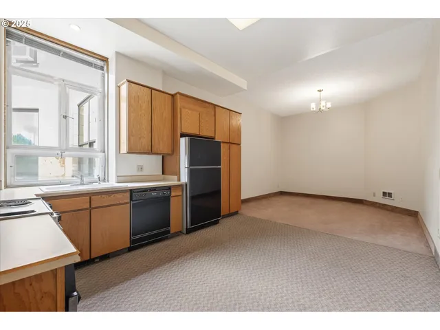 a kitchen with refrigerator cabinets and wooden floor