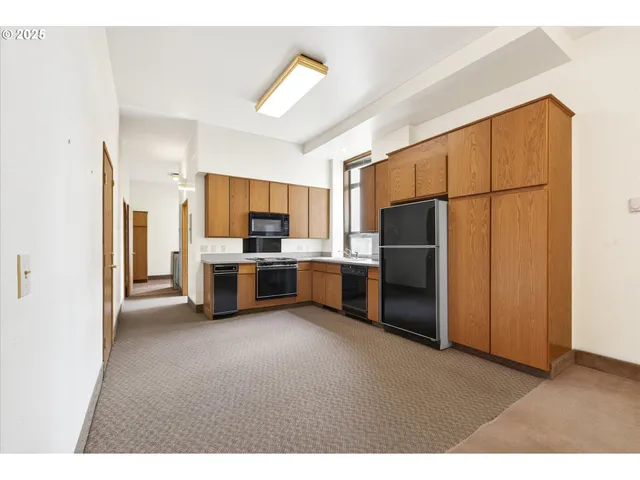 a kitchen with stainless steel appliances a refrigerator and a stove