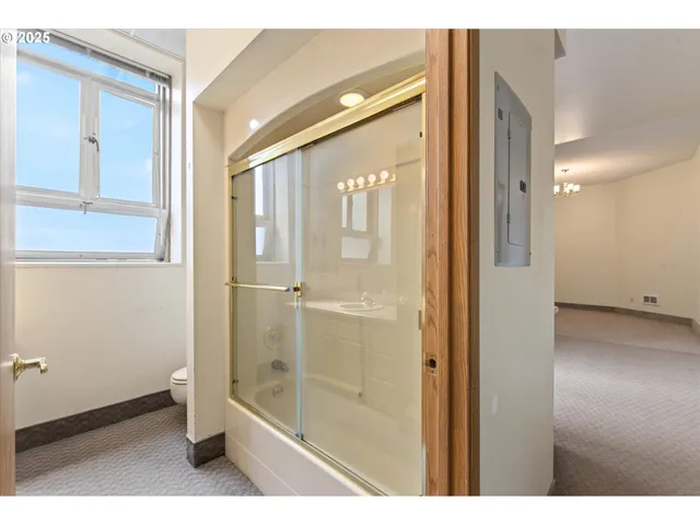 a bathroom with a glass shower door