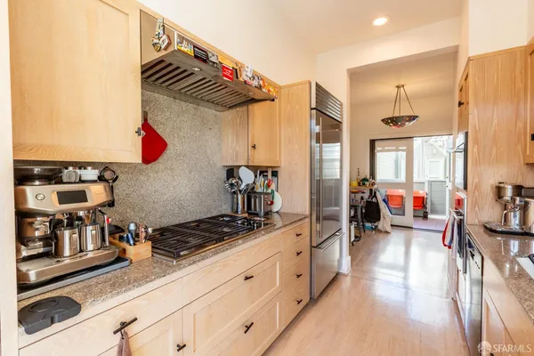 a kitchen with stainless steel appliances granite countertop a stove and a sink