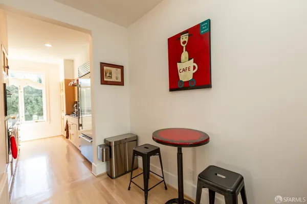 a view of a room with furniture and wooden floor