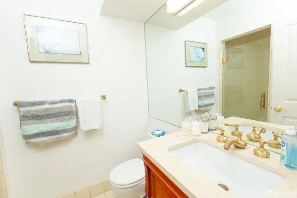 a bathroom with a sink a toilet and a mirror