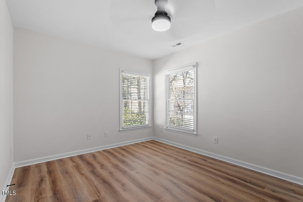 9004 Admaston Drive Raleigh, NC 27613 - Photo 28 of 30 Bedroom 4 with new LVP flooring and a ceiling fan.