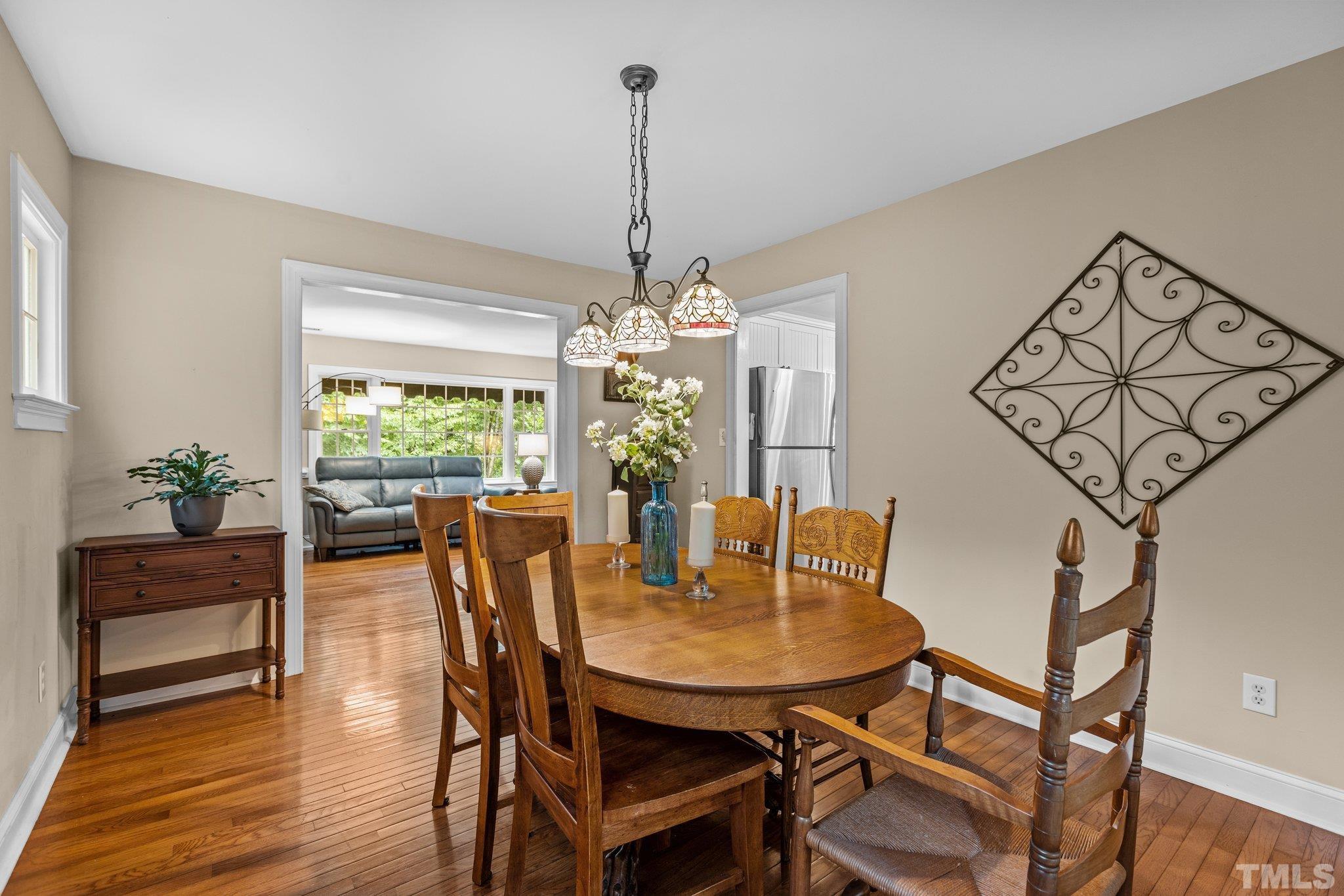 108 Rhododendron Court Chapel Hill, NC 27517 - Photo 13 of 38 a view of a dining room with furniture window and wooden floor