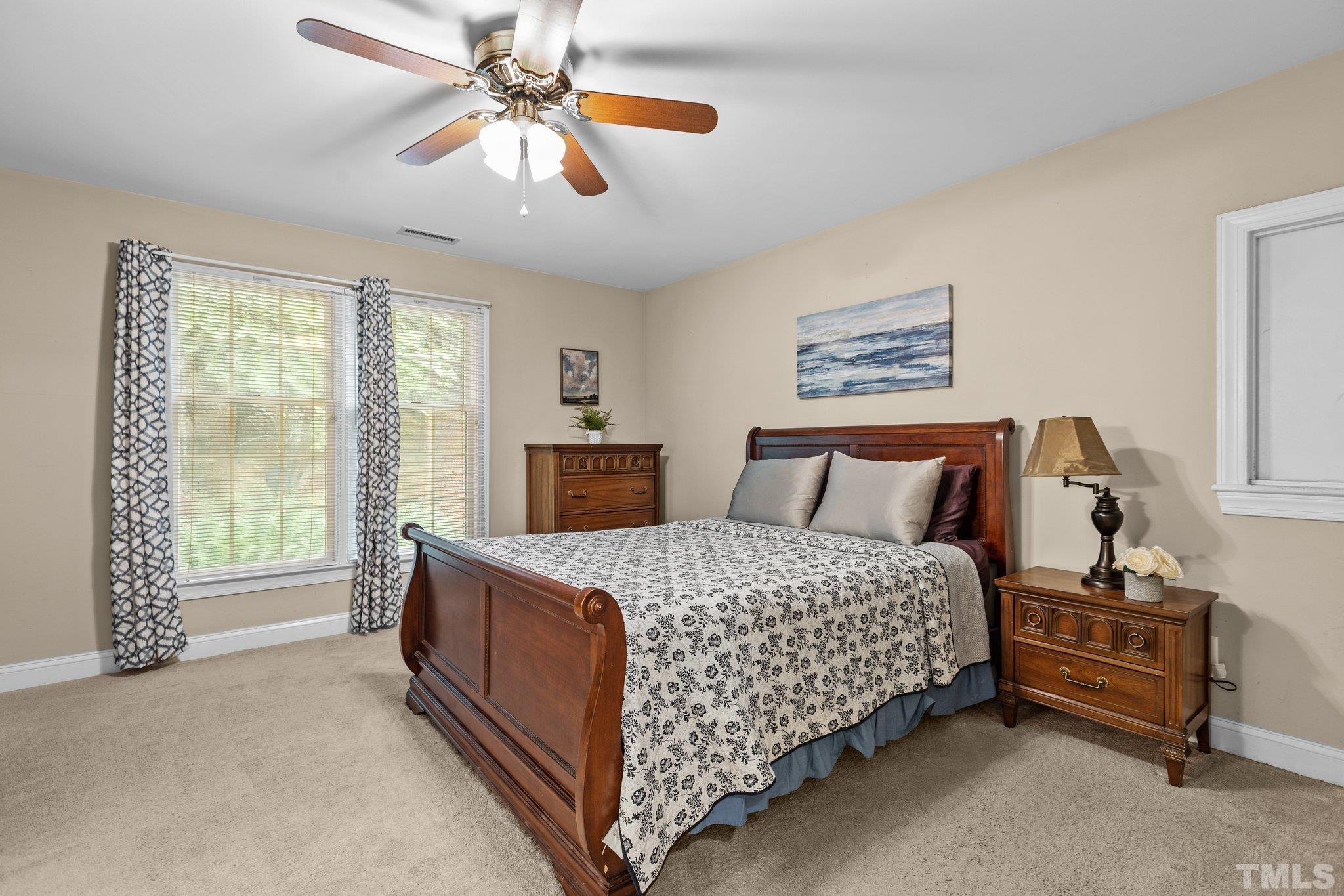 108 Rhododendron Court Chapel Hill, NC 27517 - Photo 18 of 38 a bedroom with a bed and a chandelier